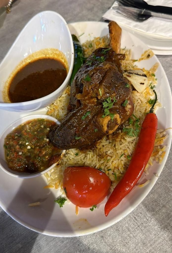 Tender slow-cooked lamb shank served over spiced basmati rice with daqqous tomato salsa and gravy sauce.
