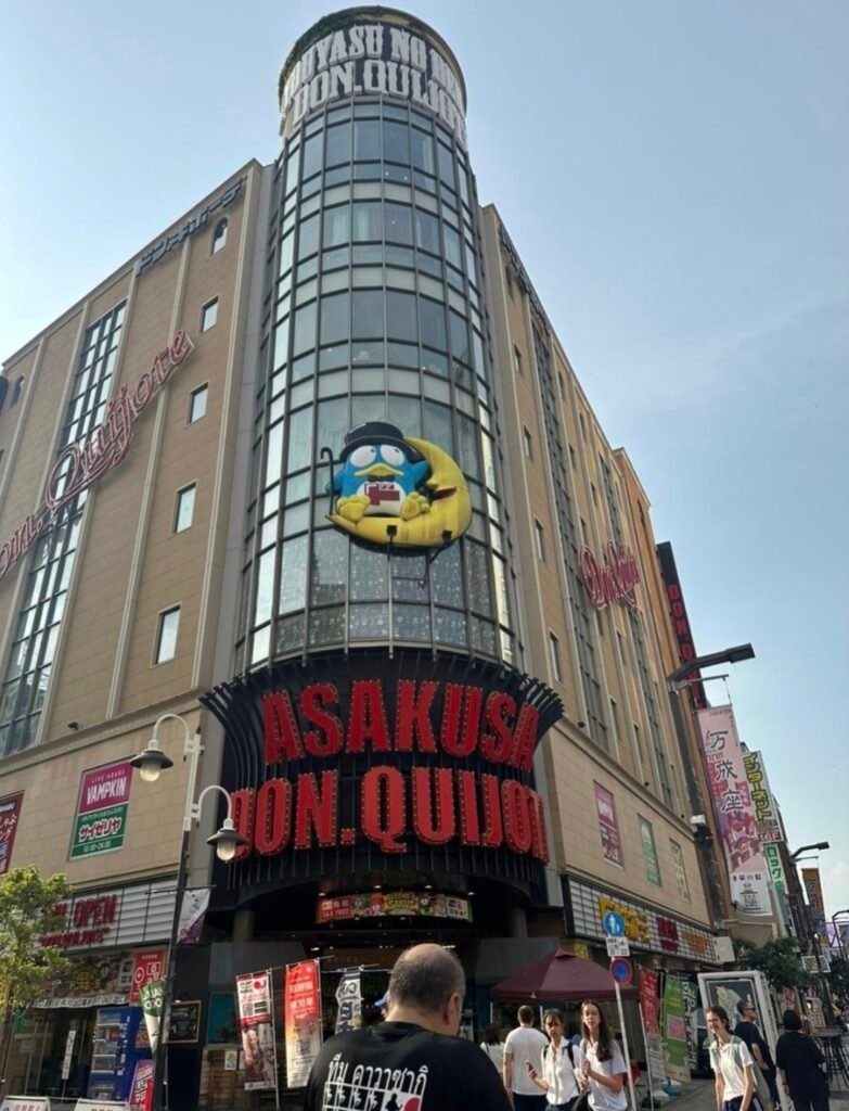 Exterior storefront of the multi-story Asakusa Don Quijote discount shop in Tokyo featuring the Donpen mascot.