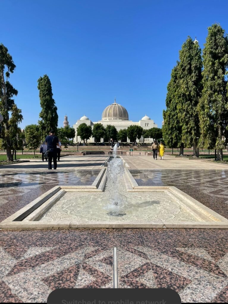  A beautiful fountain and stone courtyard leading up to the main dome of the Sultan Qaboos Grand Mosque in Muscat, Oman.